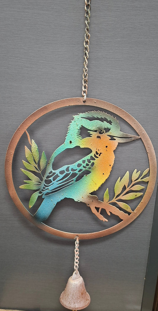 Decorative wall hanging with a colorful bird design on a dark surface