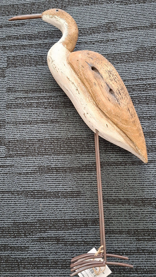 Decorative bird-shaped object on a textured gray surface