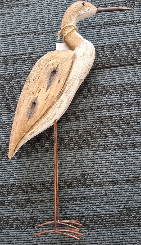 Decorative bird sculpture on a stand against a textured gray background