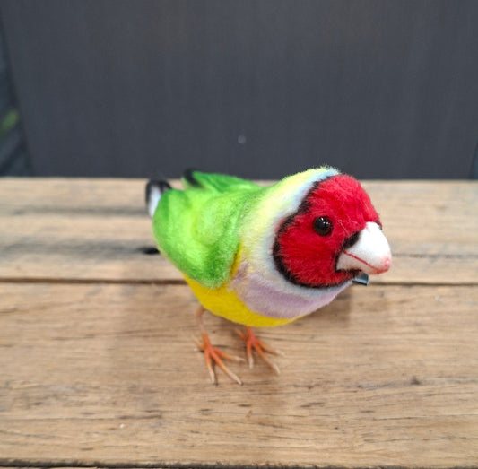 Colorful bird figurine on a wooden surface