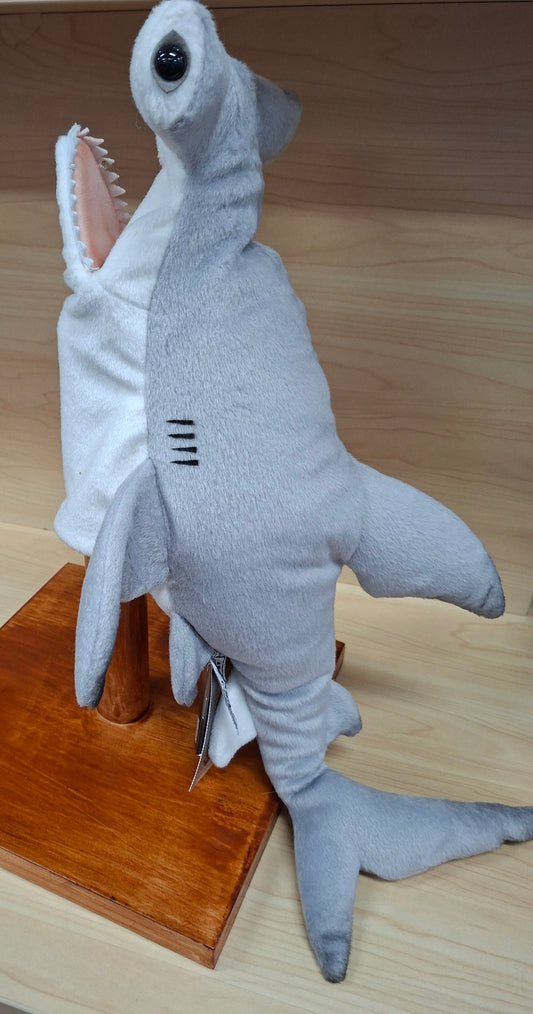 Plush shark toy on a wooden surface