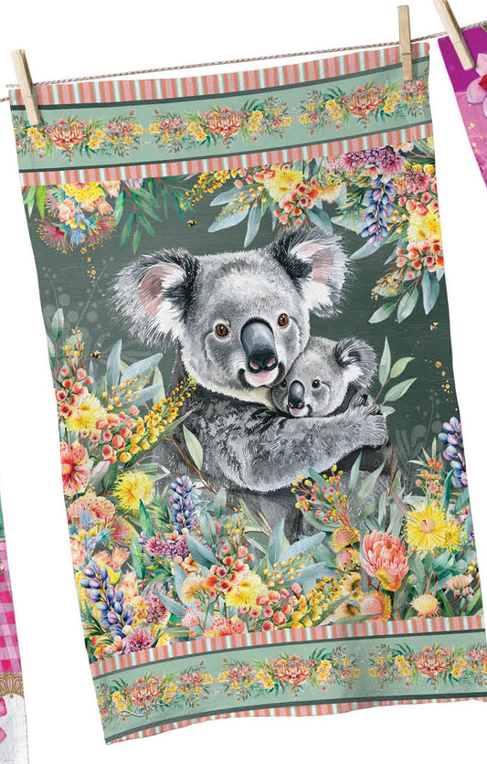 Three colorful tea towels with animal designs hanging on a line against a white background.
