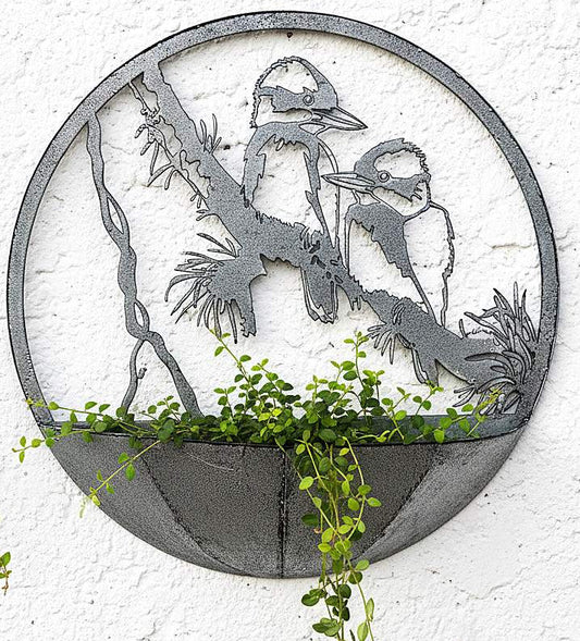 Decorative metal wall art with kookaburra design on a white wall.